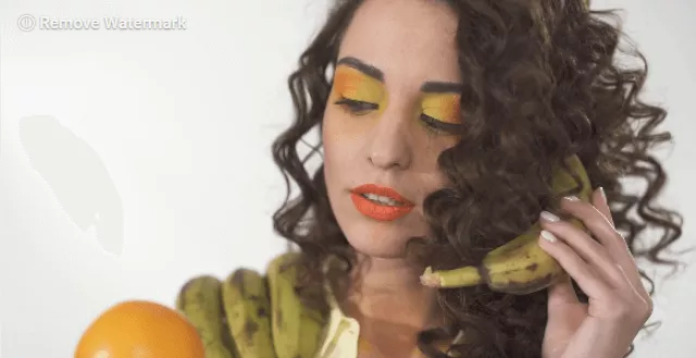 An Imitating Women with a Banana and Orange on Hands