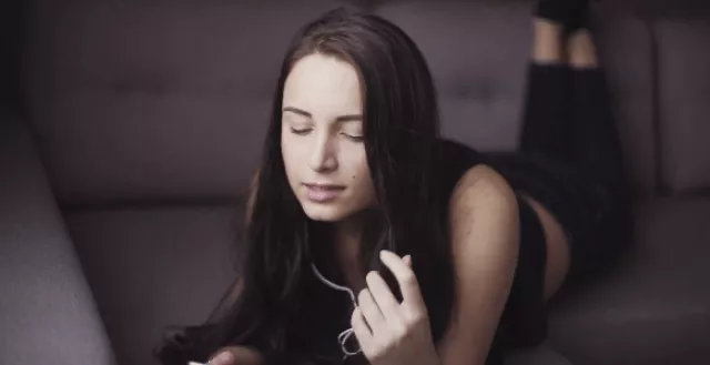 A Singing Women Wearing Earphones